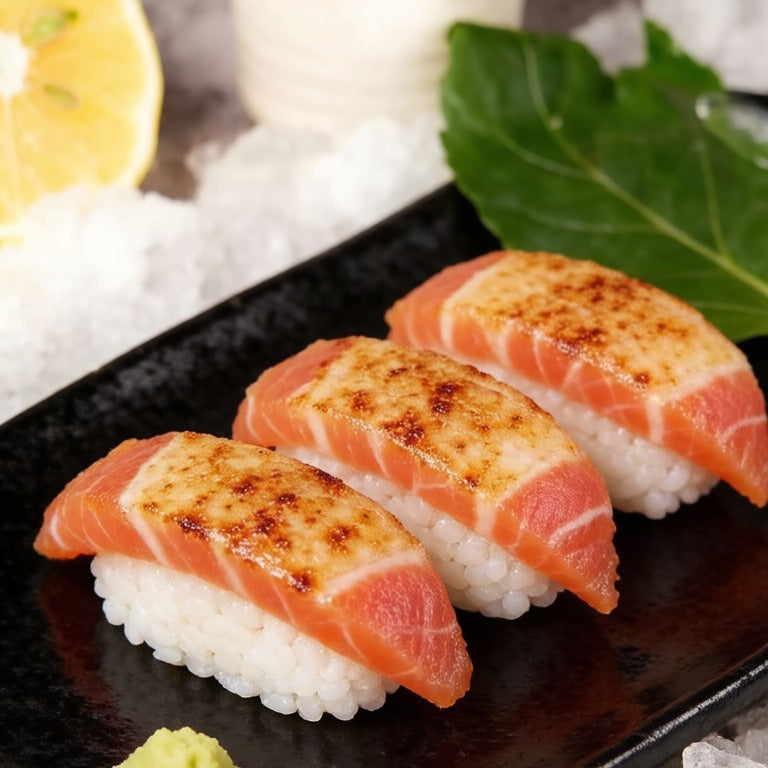 Torched tuna nigiri sushi on a black slate